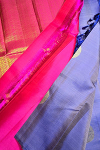 Two pieces of fabric, one pink and one blue, draped over a surface.