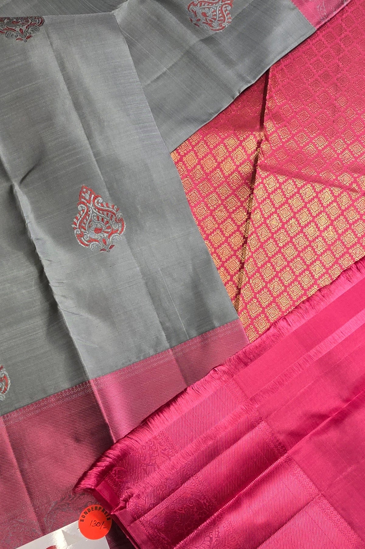 Pink and gray saree with intricate patterns