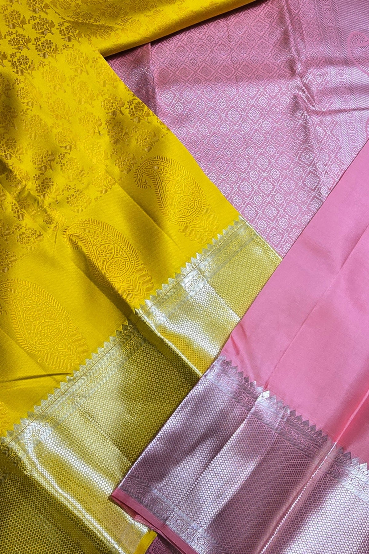 Close-up of yellow and pink fabric with intricate patterns