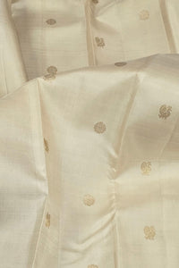 Close-up of a cream fabric with gold floral patterns