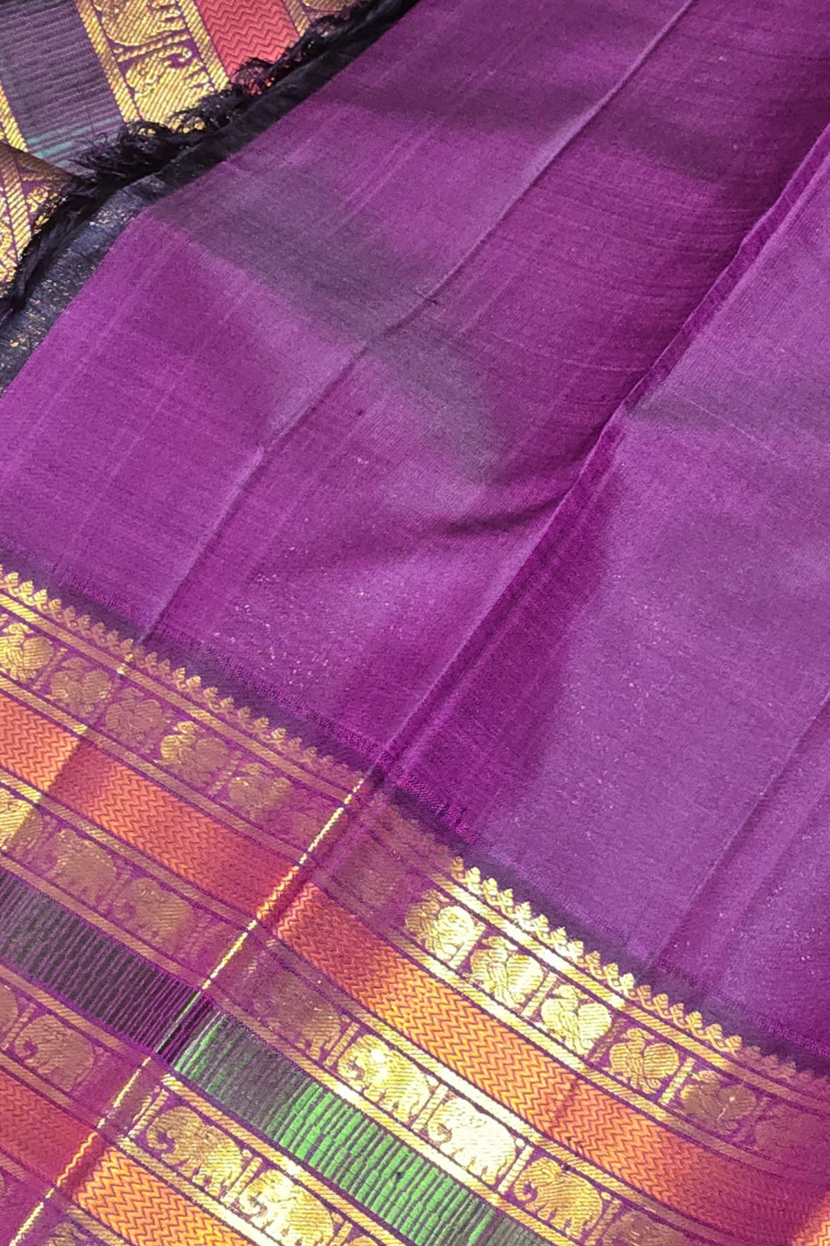 Purple saree with a colorful border
