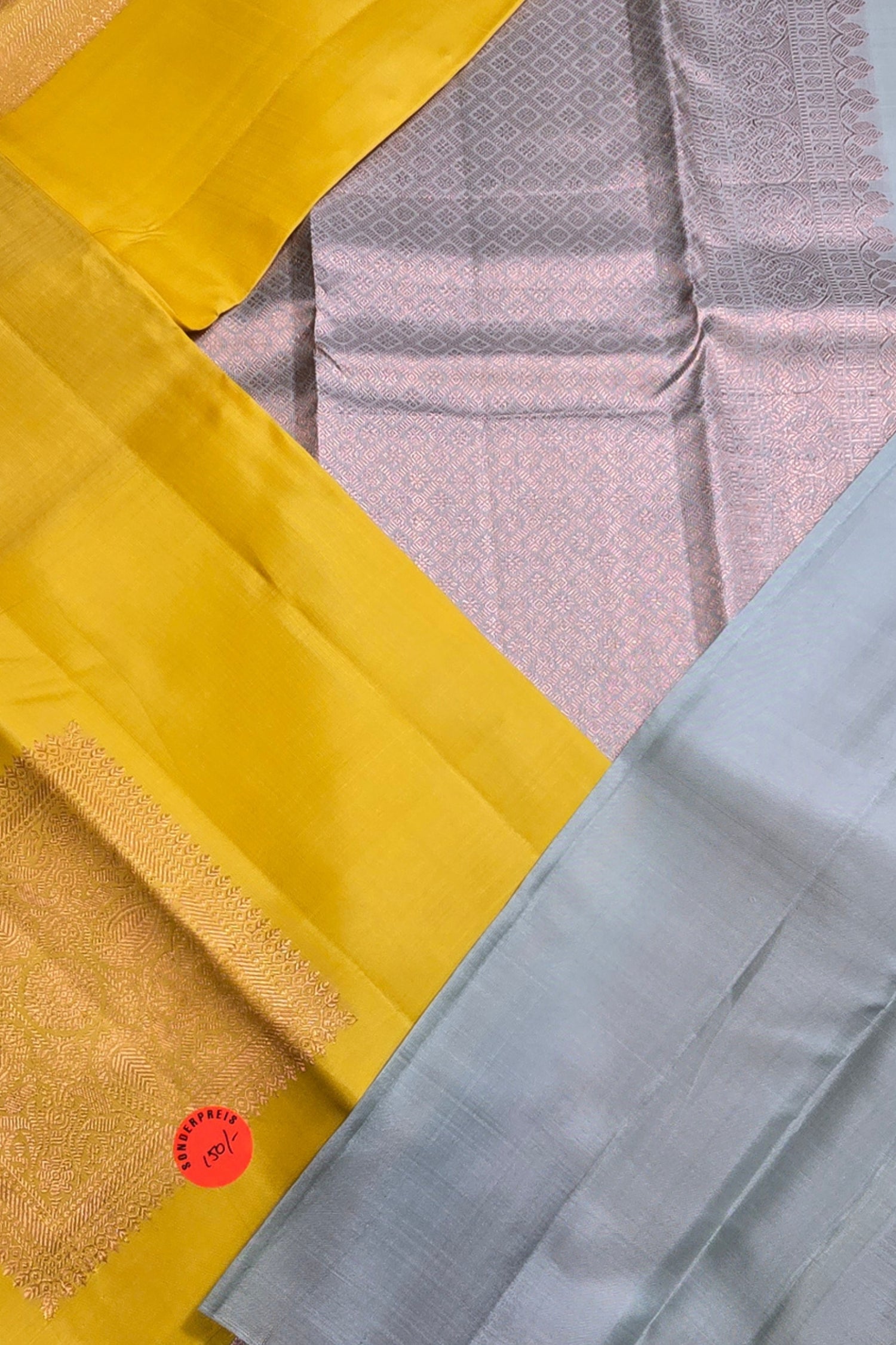 Close-up of a yellow and gray fabric with a textured pattern
