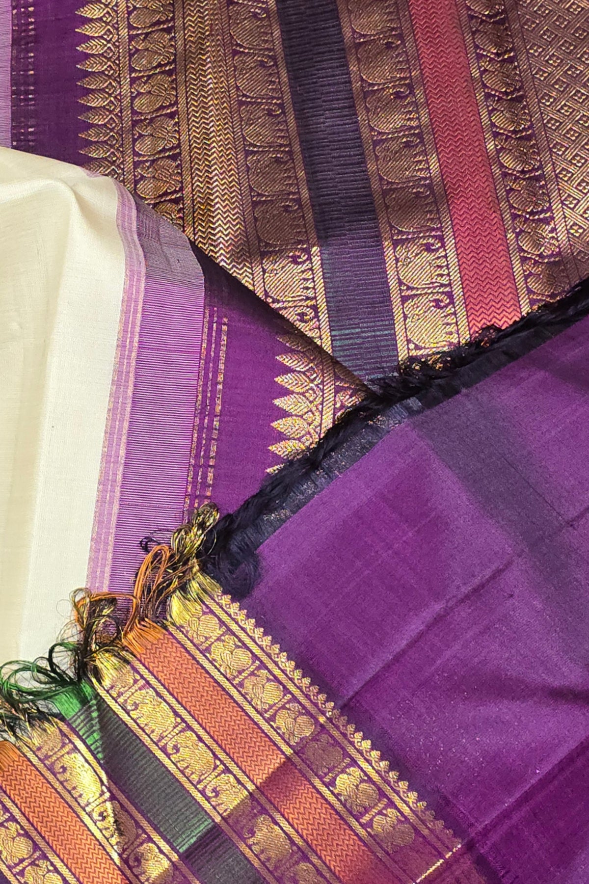 Close-up of a purple fabric with intricate patterns and borders