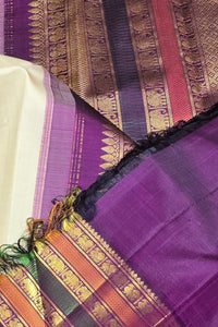 Close-up of a purple fabric with intricate patterns and borders