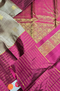 Pink and gold patterned fabric with a brand label in the corner