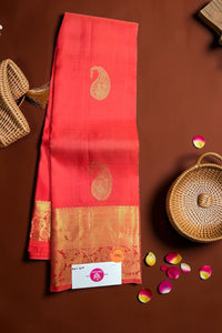 Red saree with gold border on a brown background