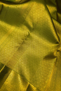 green saree with gold zari border showcasing intricate gold zari design on rich green fabric