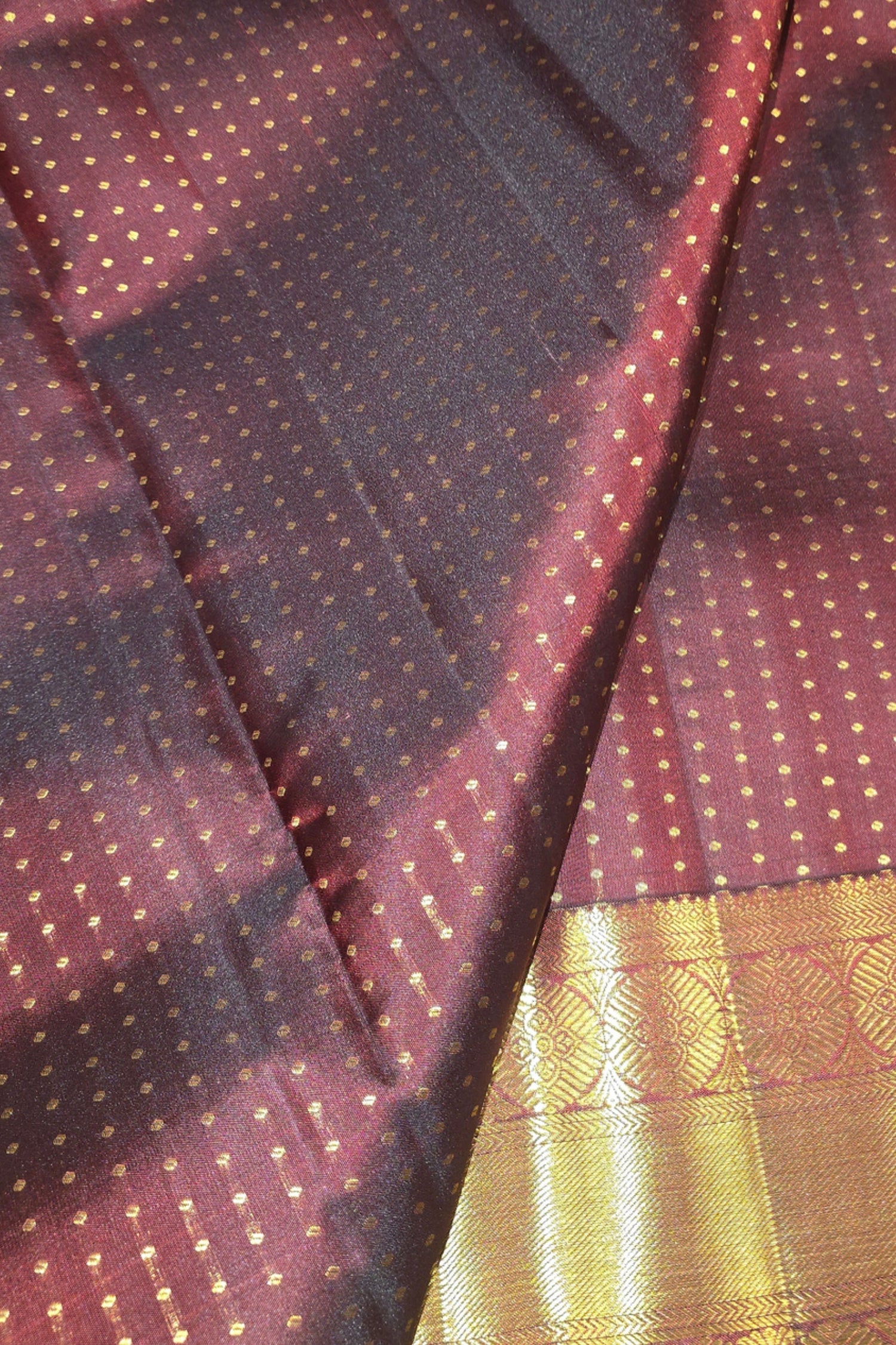 Close-up of a maroon fabric with gold patterns