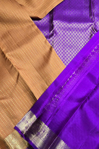 Close-up of a brown and purple fabric with a visible pattern