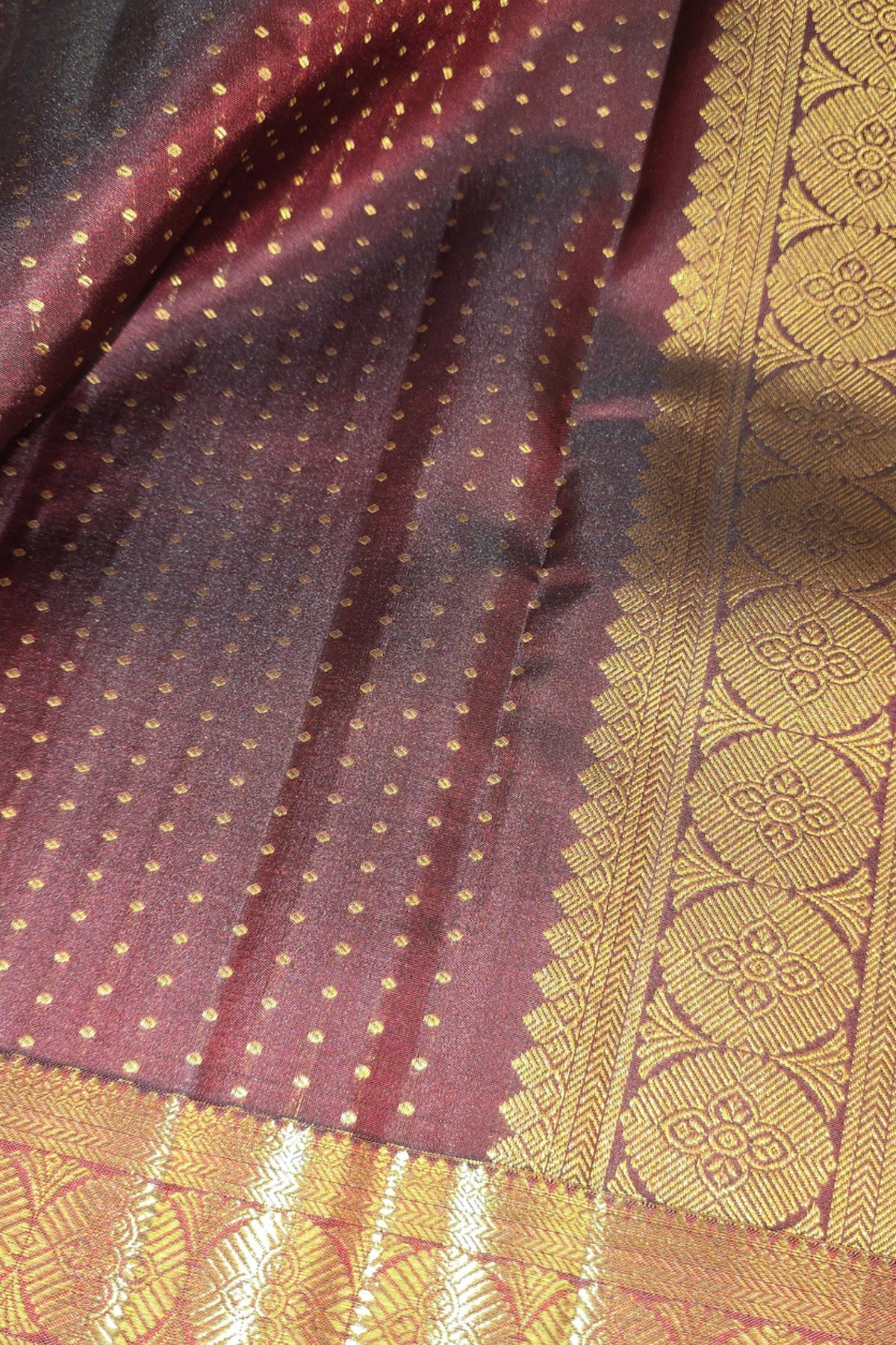 Close-up of a maroon fabric with gold patterns