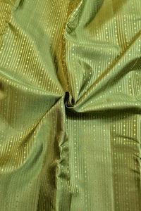 A close-up of olive green fabric with a subtle sheen and vertical dotted metallic-looking stripes, gathered in the center to show texture and drape.