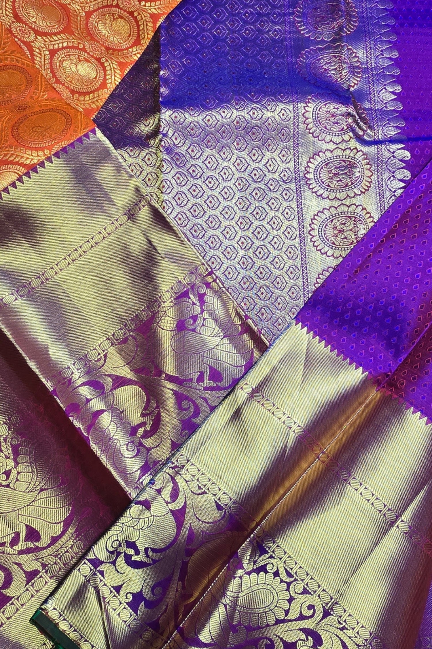 Close-up of a saree with purple and orange patterns