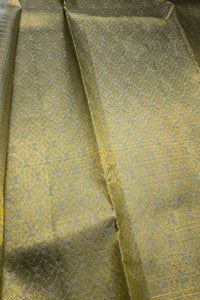 Intricate gold zari fabric texture, perfect for a light sage green silk saree.