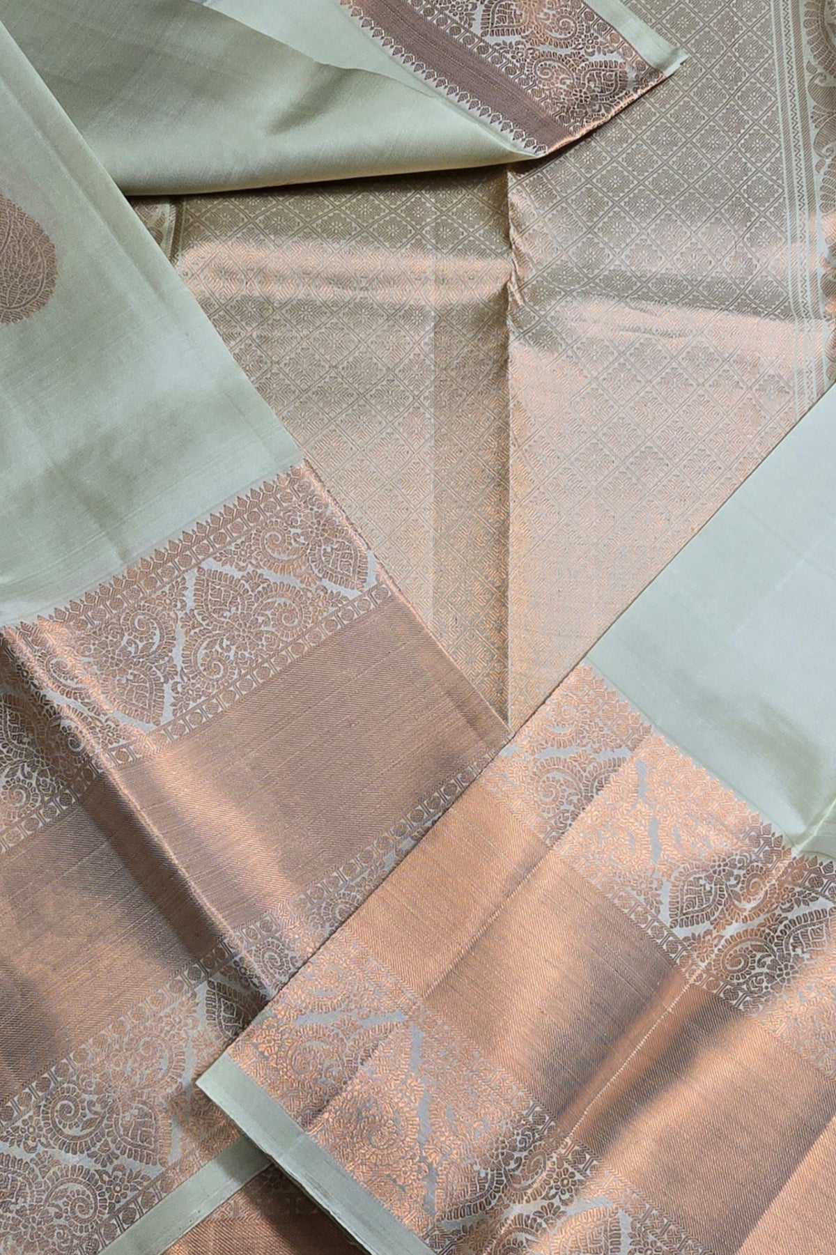 Close-up of patterned fabric in shades of green and brown.