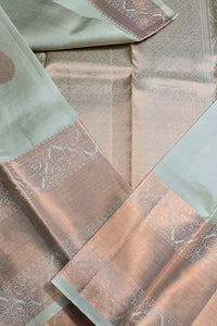 Close-up of patterned fabric in shades of green and brown.