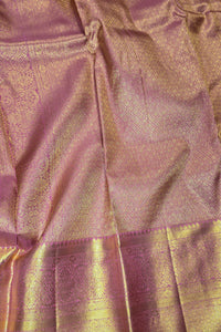 Close-up of pink and gold fabric with intricate patterns