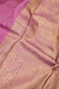 Close-up of a pink fabric with gold patterns