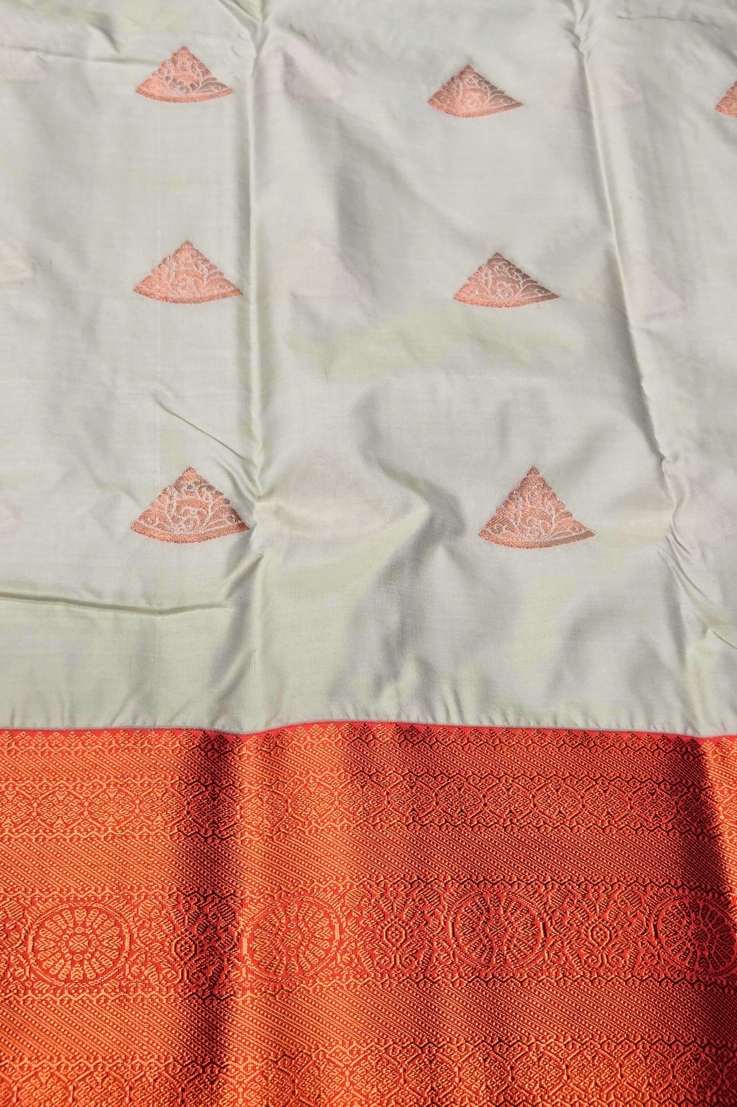 White fabric with pink triangle patterns and a red border