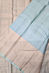 Close-up of a fabric with a light blue border on a textured beige background
