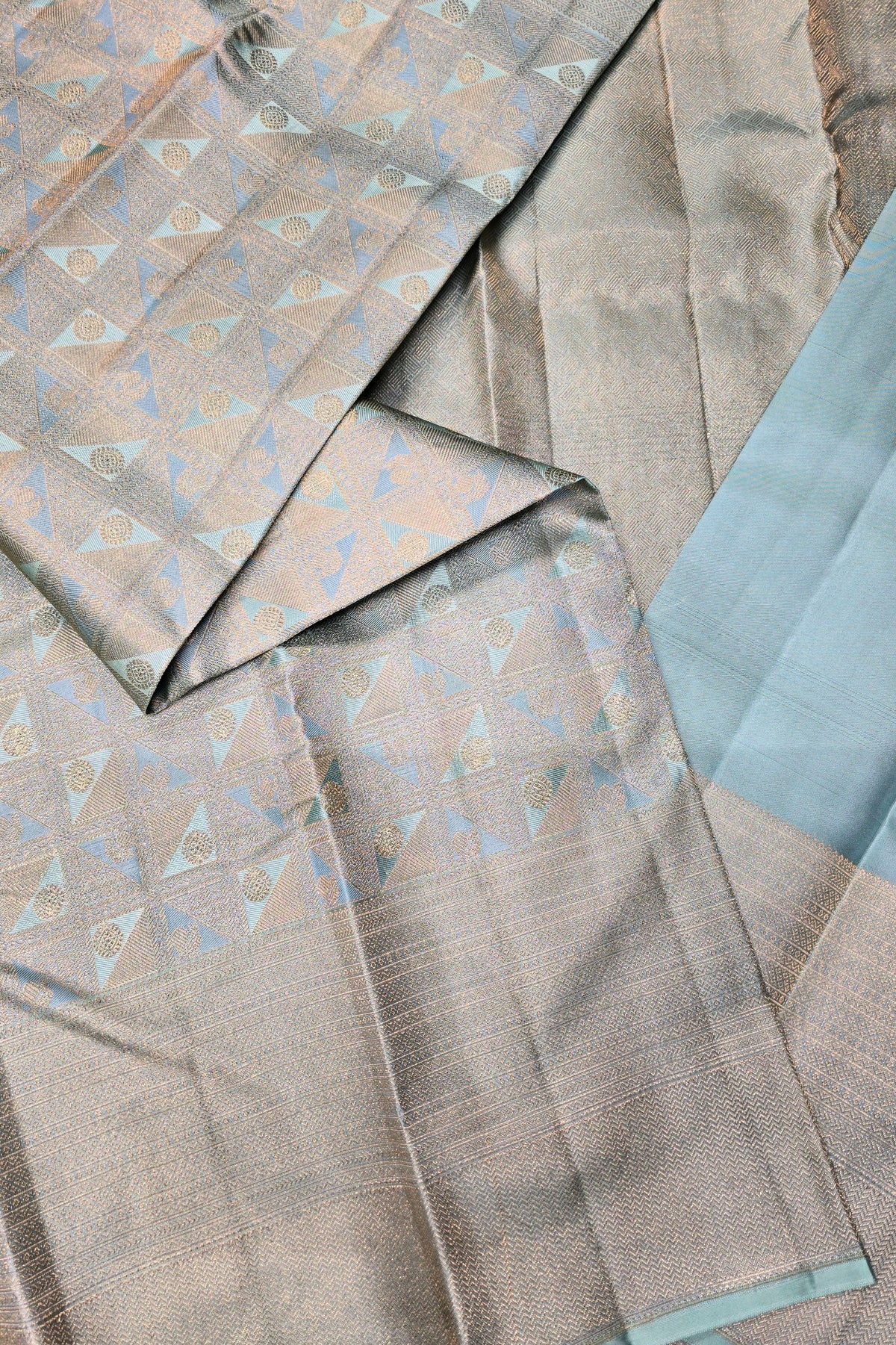 Textured fabric with geometric pattern in shades of brown and blue.