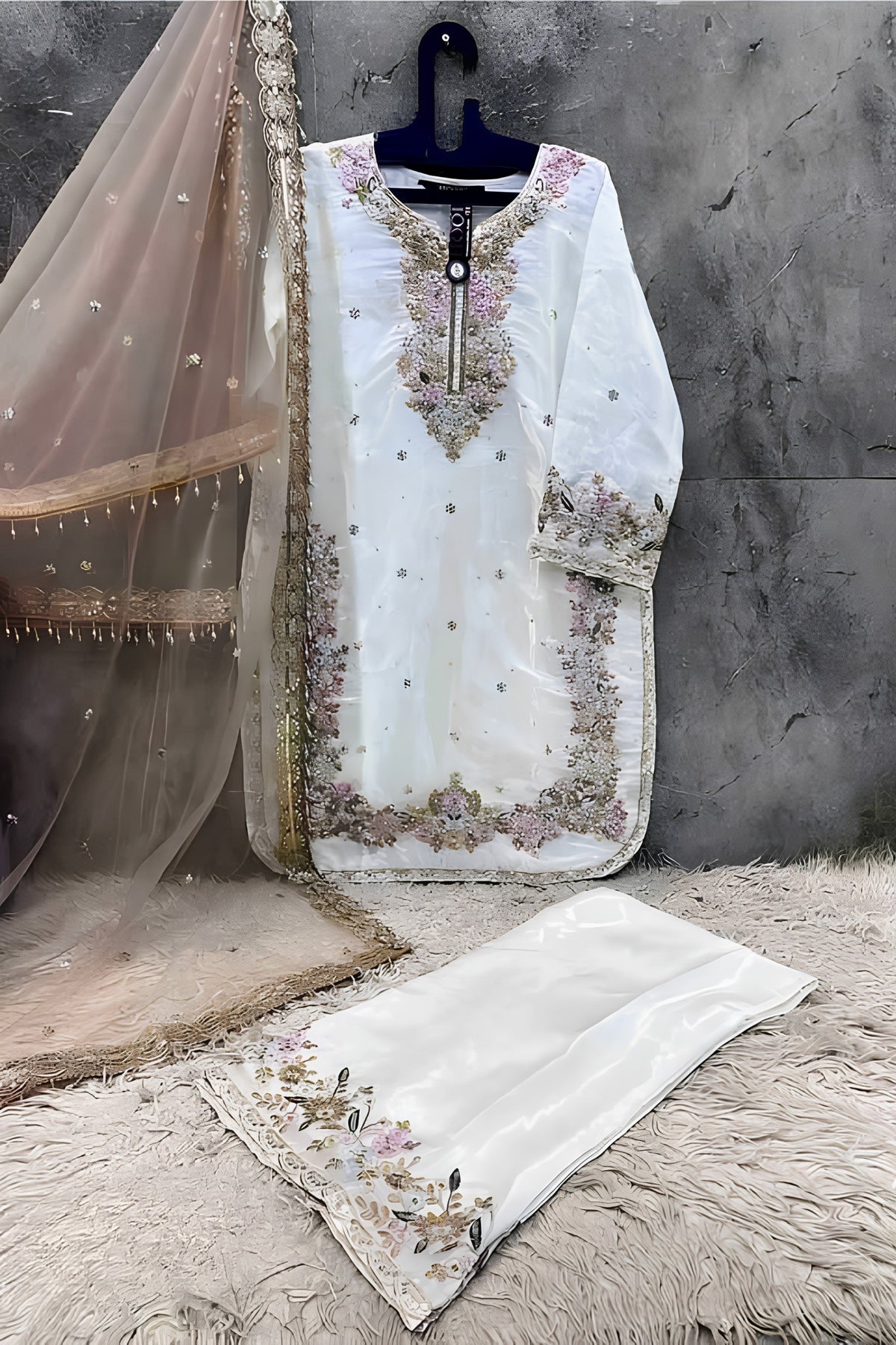 White embroidered kurta with dupatta on a textured surface