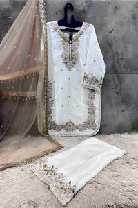 White embroidered kurta with dupatta on a textured surface