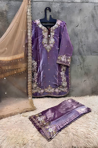 Purple embroidered traditional outfit with a matching dupatta on a textured surface.