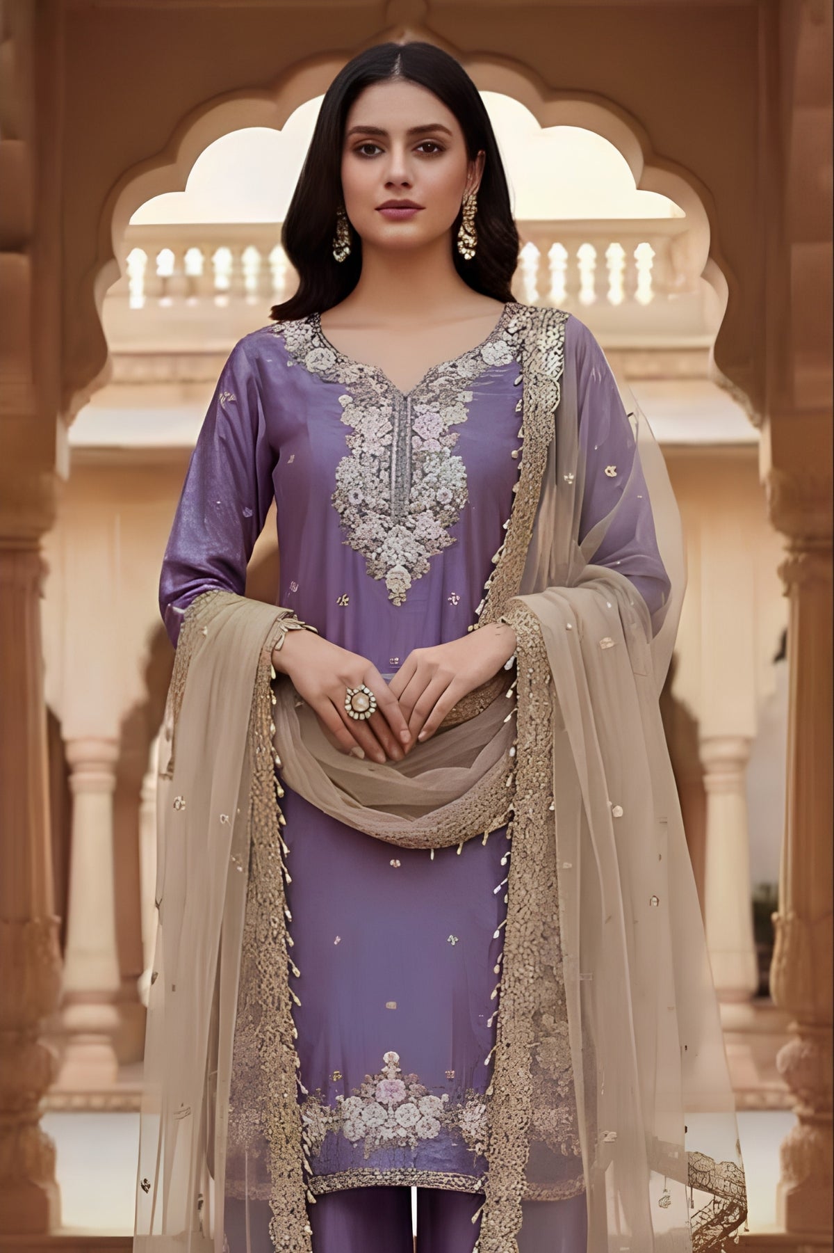 Woman in traditional outfit with intricate embroidery in a decorative setting