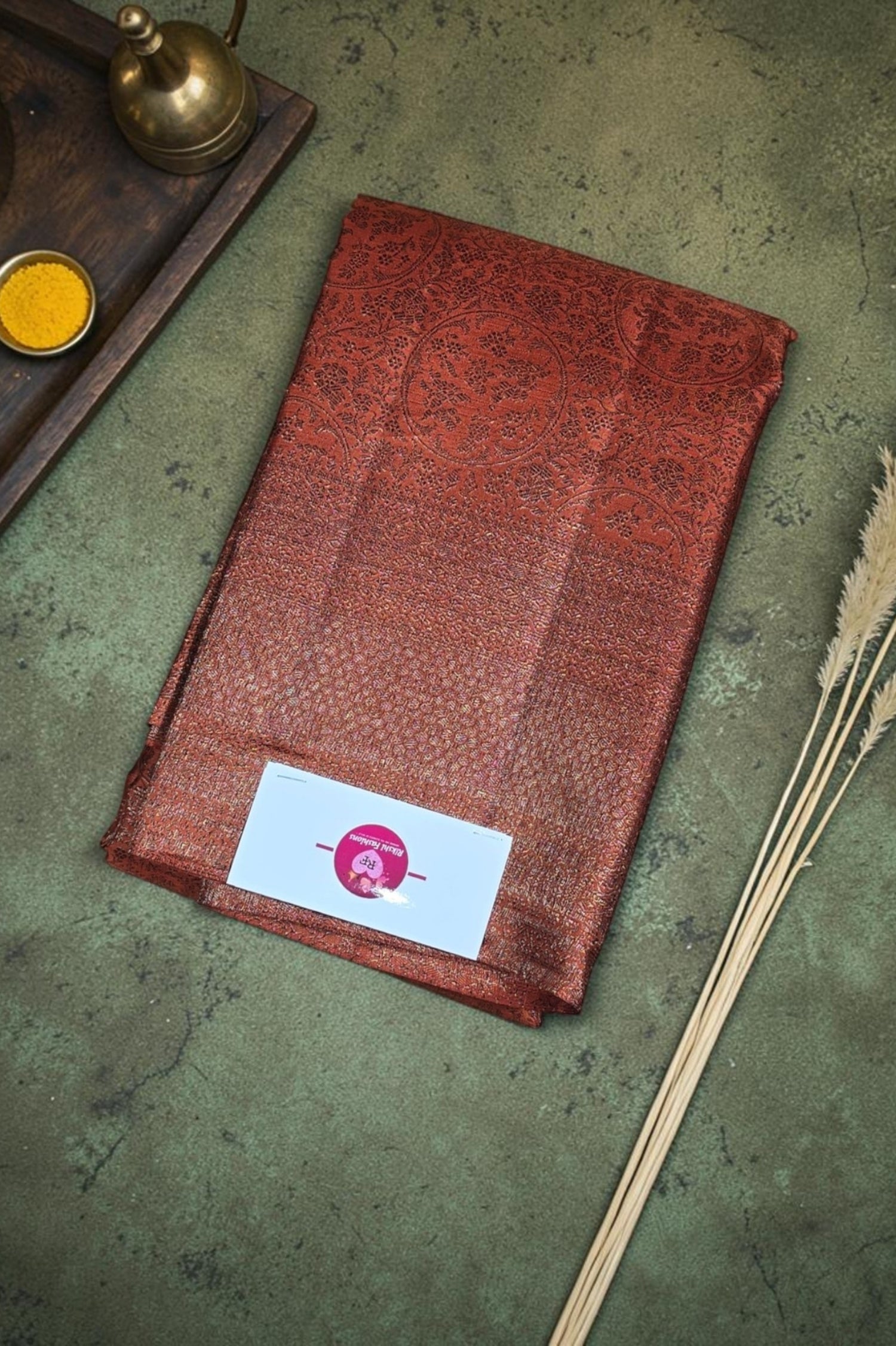 Red patterned fabric with a brand label on a textured surface