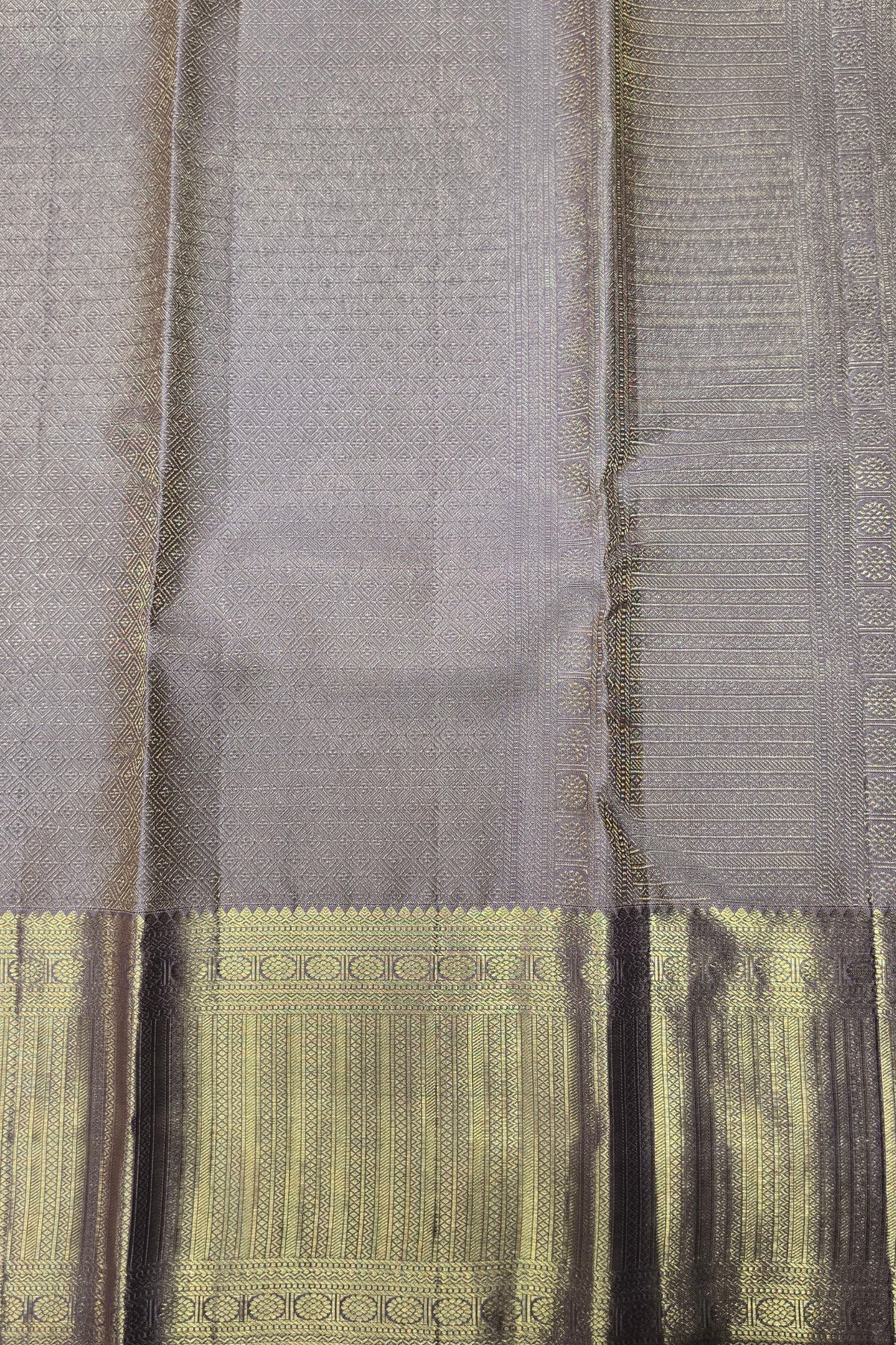 Close-up of a gray fabric with intricate patterns and designs.