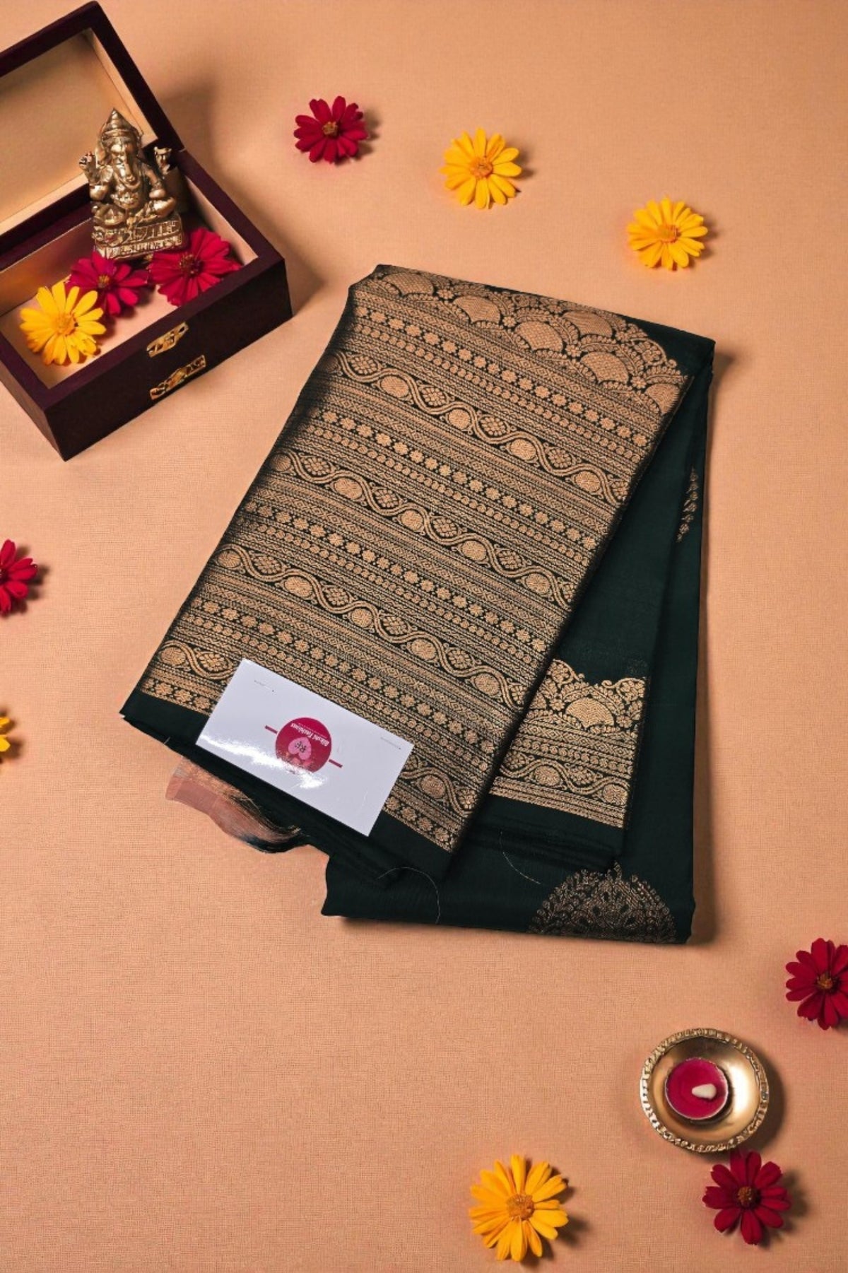 Black saree with gold patterns on a beige background with decorative elements