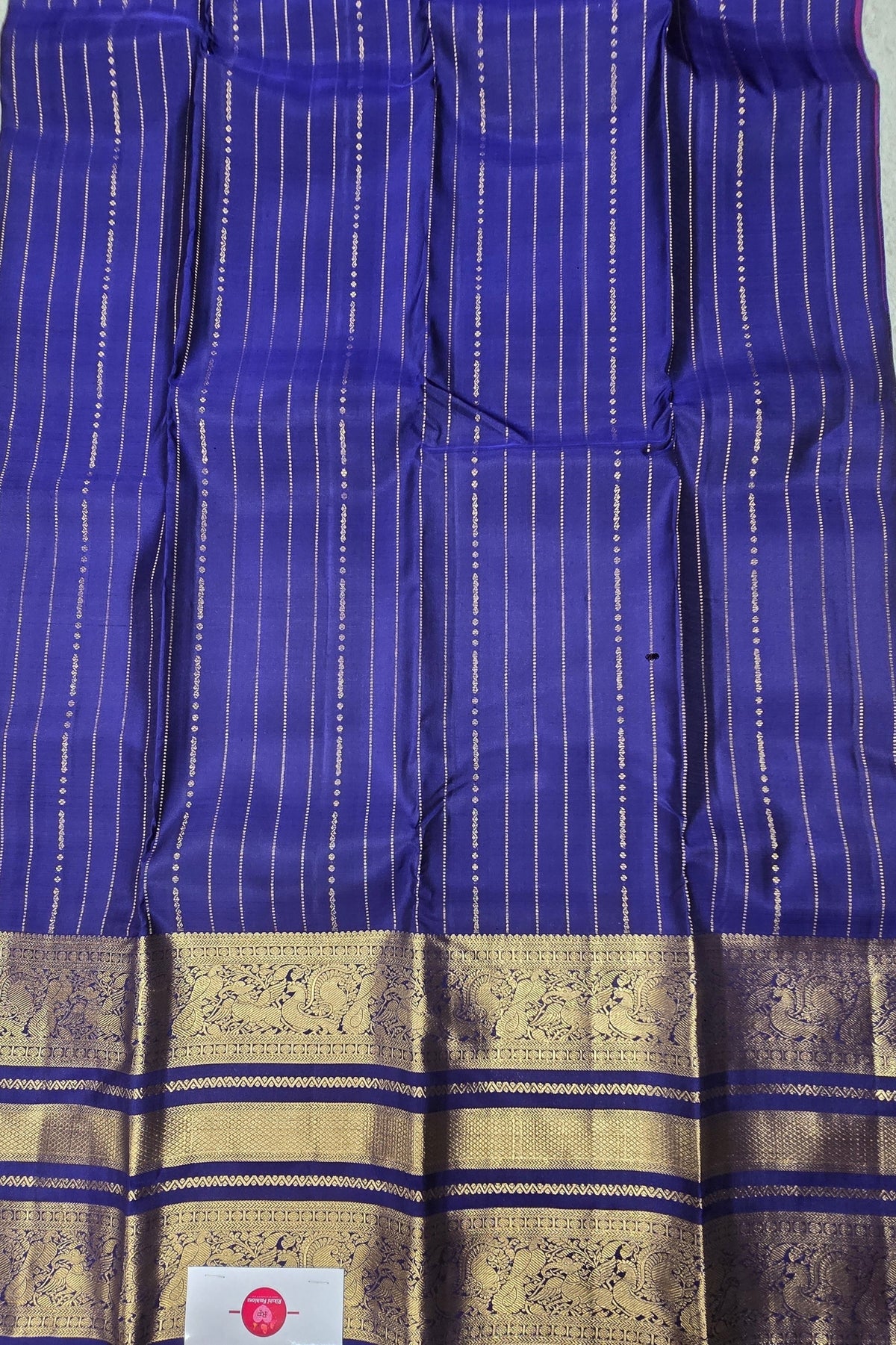 Blue fabric with gold border and label