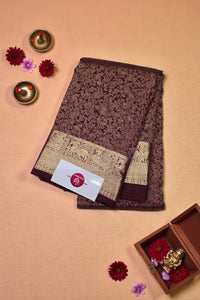 Brown and gold patterned fabric with a brand label on a beige background