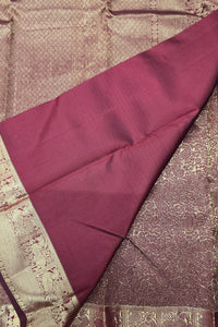 Purple fabric with intricate patterns on a textured background