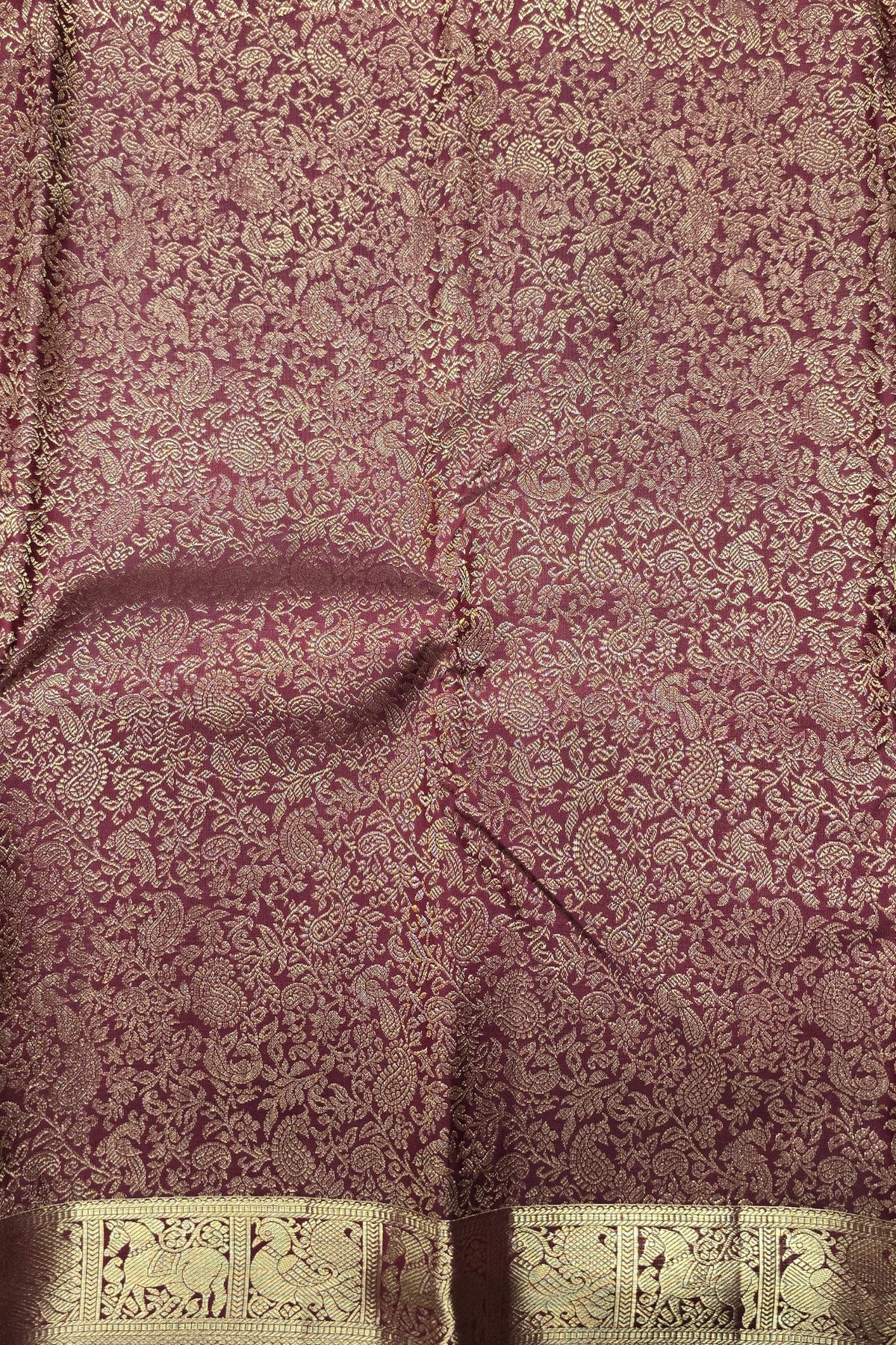 Close-up of a textured fabric with a floral pattern on a dark background