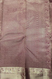 Close-up of a purple fabric with intricate patterns and embroidery.