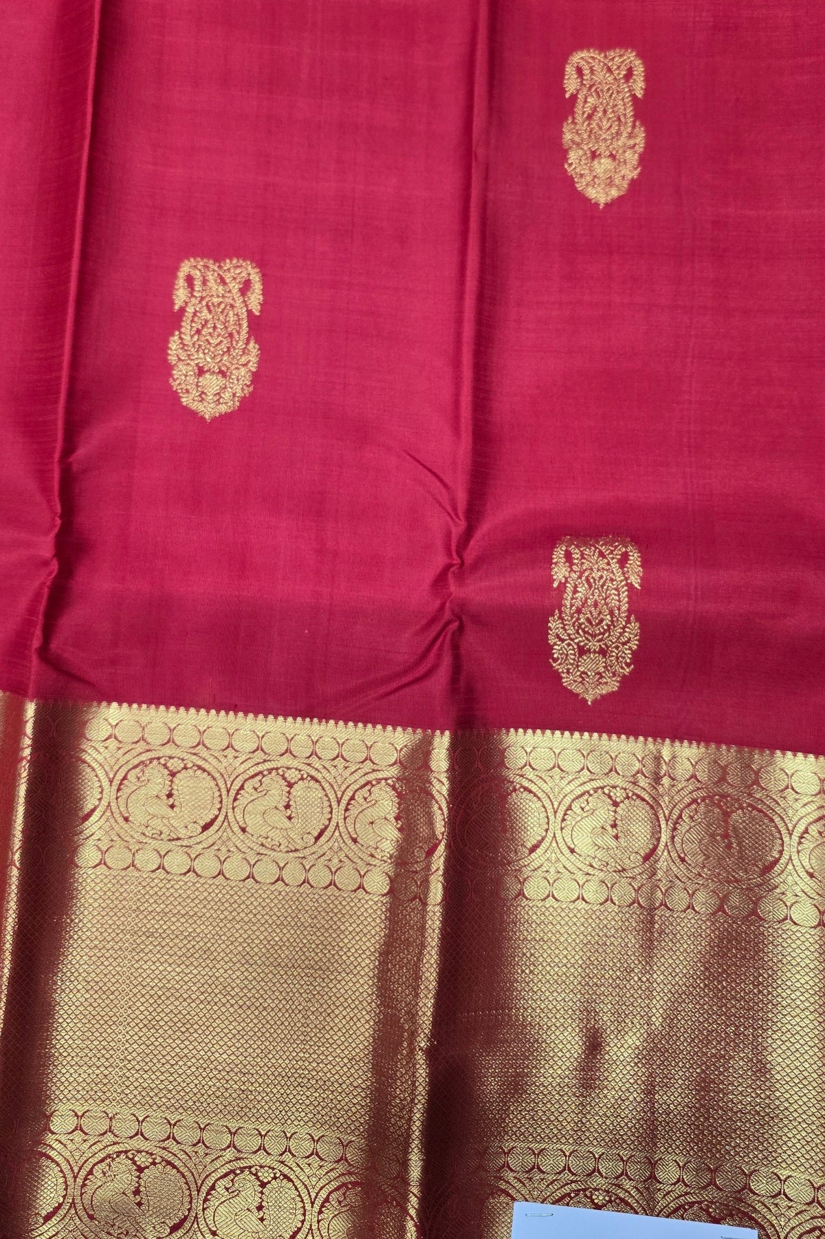 Red fabric with gold embroidery and patterns
