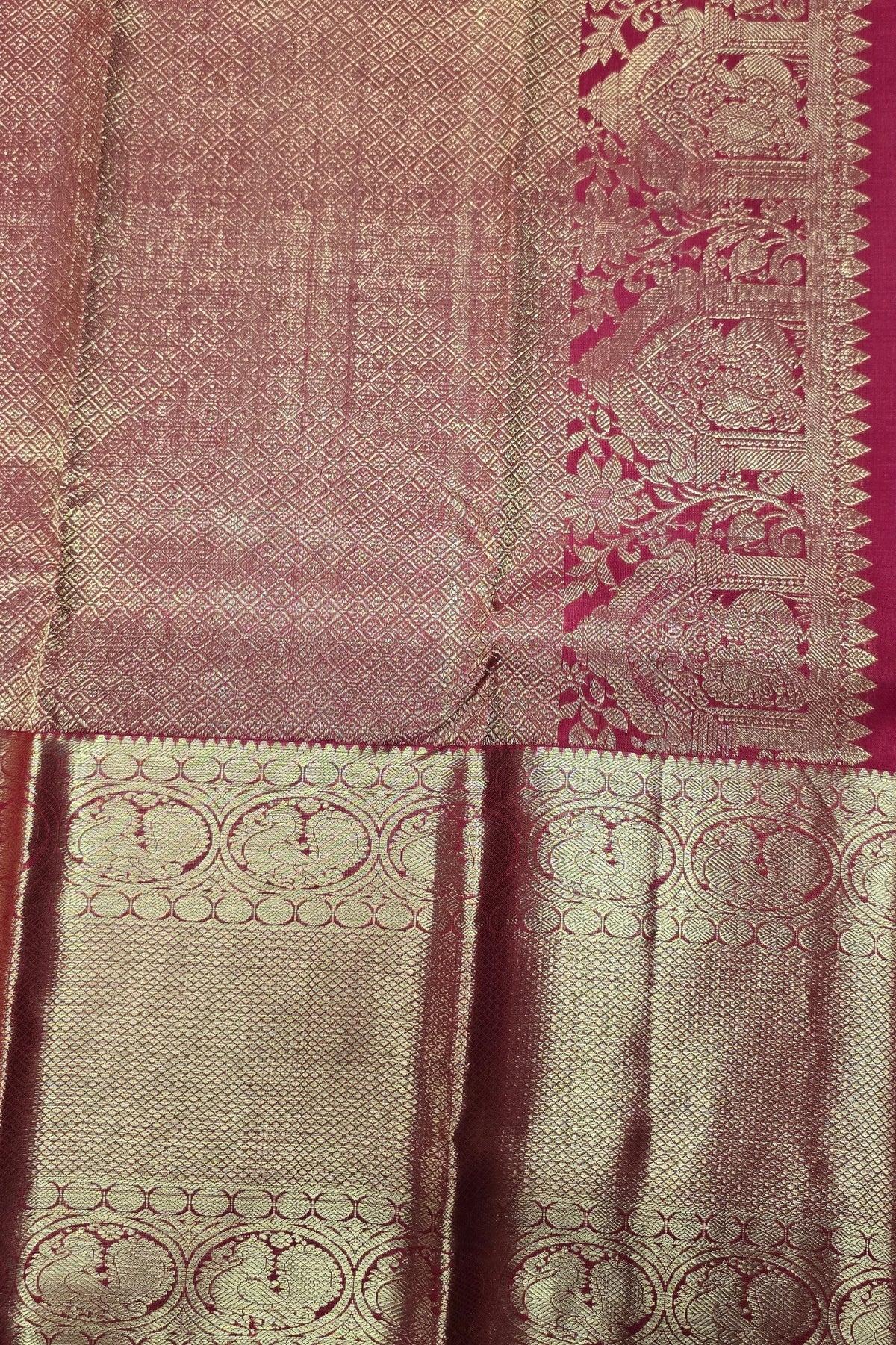 Close-up of a pink and beige fabric with intricate patterns