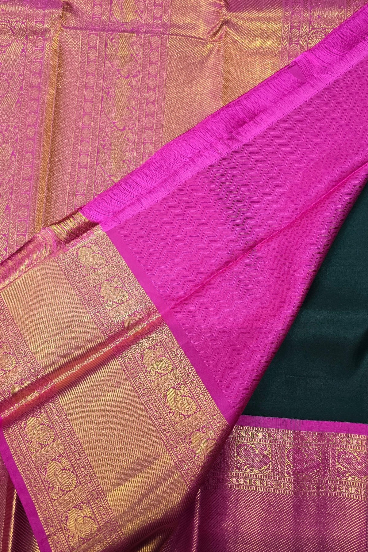 Close-up of a pink and gold saree with intricate patterns
