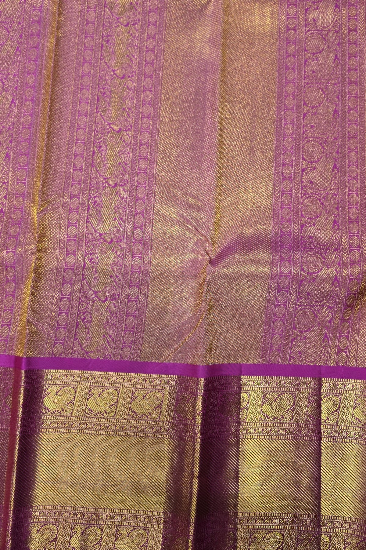 Purple and gold traditional fabric with intricate patterns