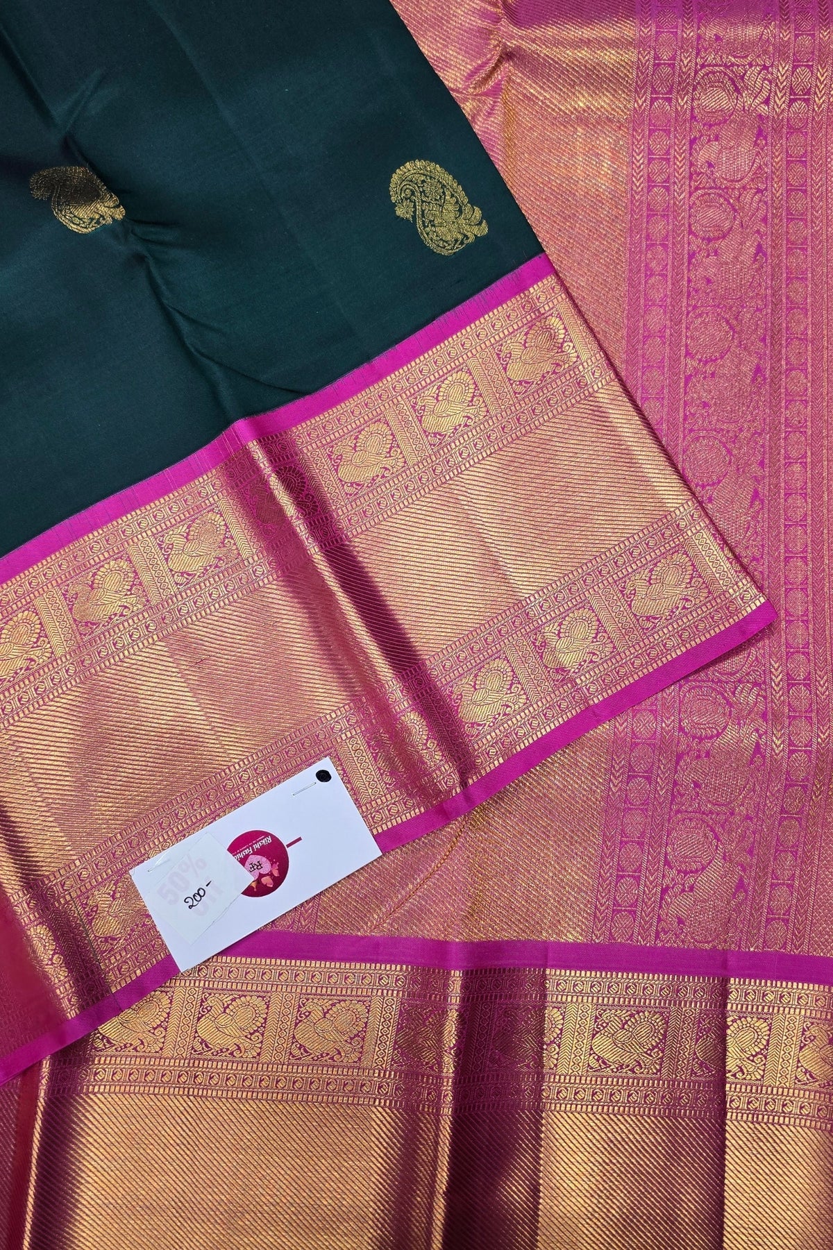 Traditional saree with intricate patterns and a brand card in the foreground