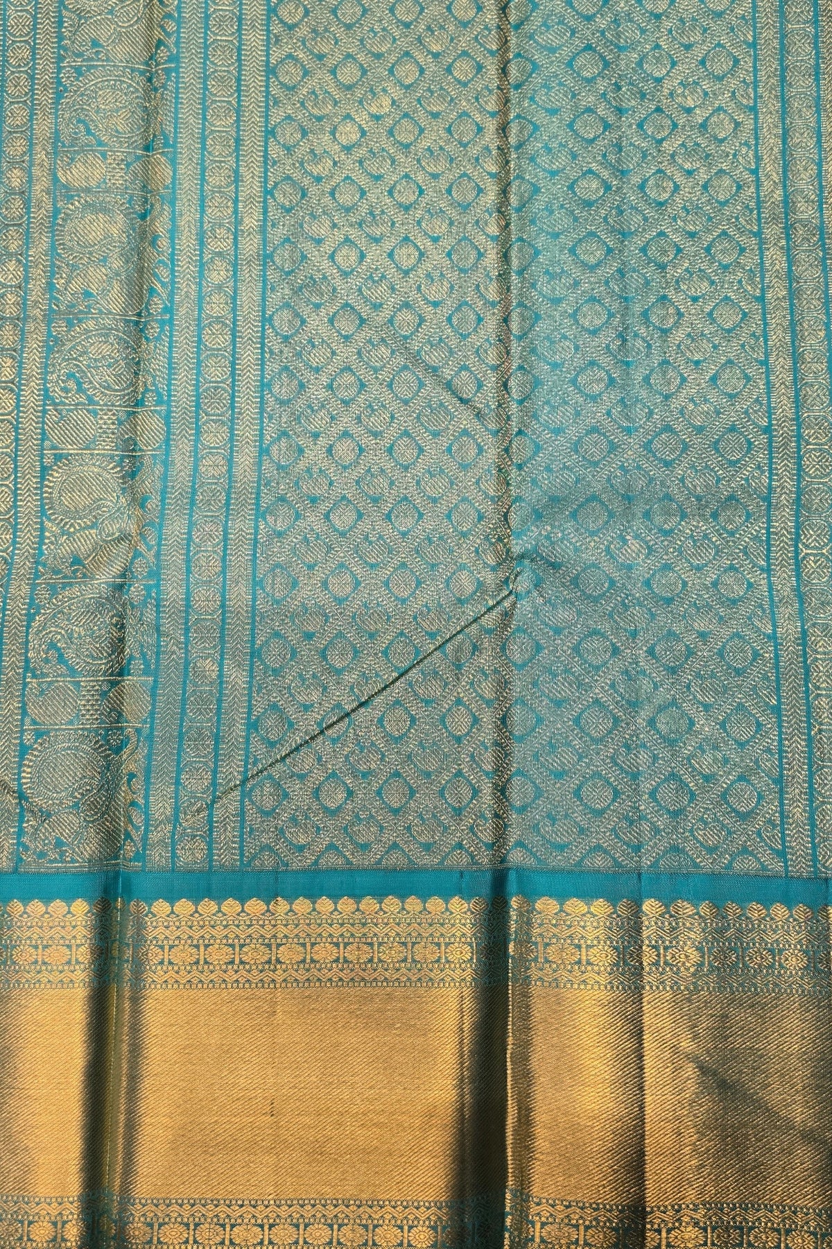 Teal and gold fabric with intricate patterns