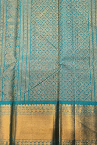 Teal and gold fabric with intricate patterns