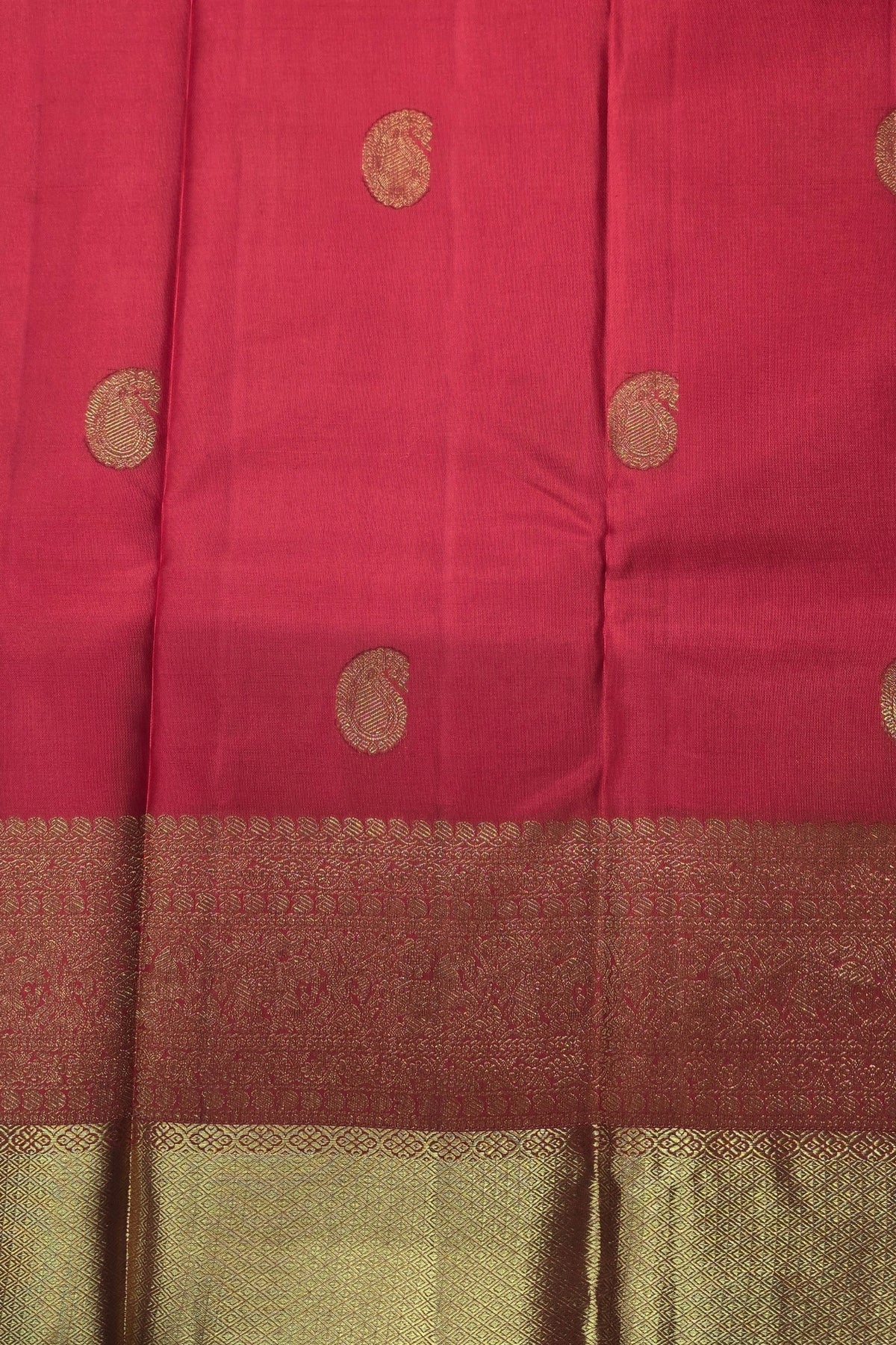 Red fabric with gold circular patterns and a brown border