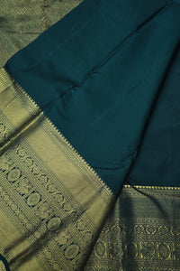 Teal and green traditional fabric with intricate patterns