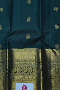Dark green fabric with gold patterns and a visible brand label.