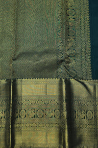 Green fabric with intricate gold patterns and embroidery