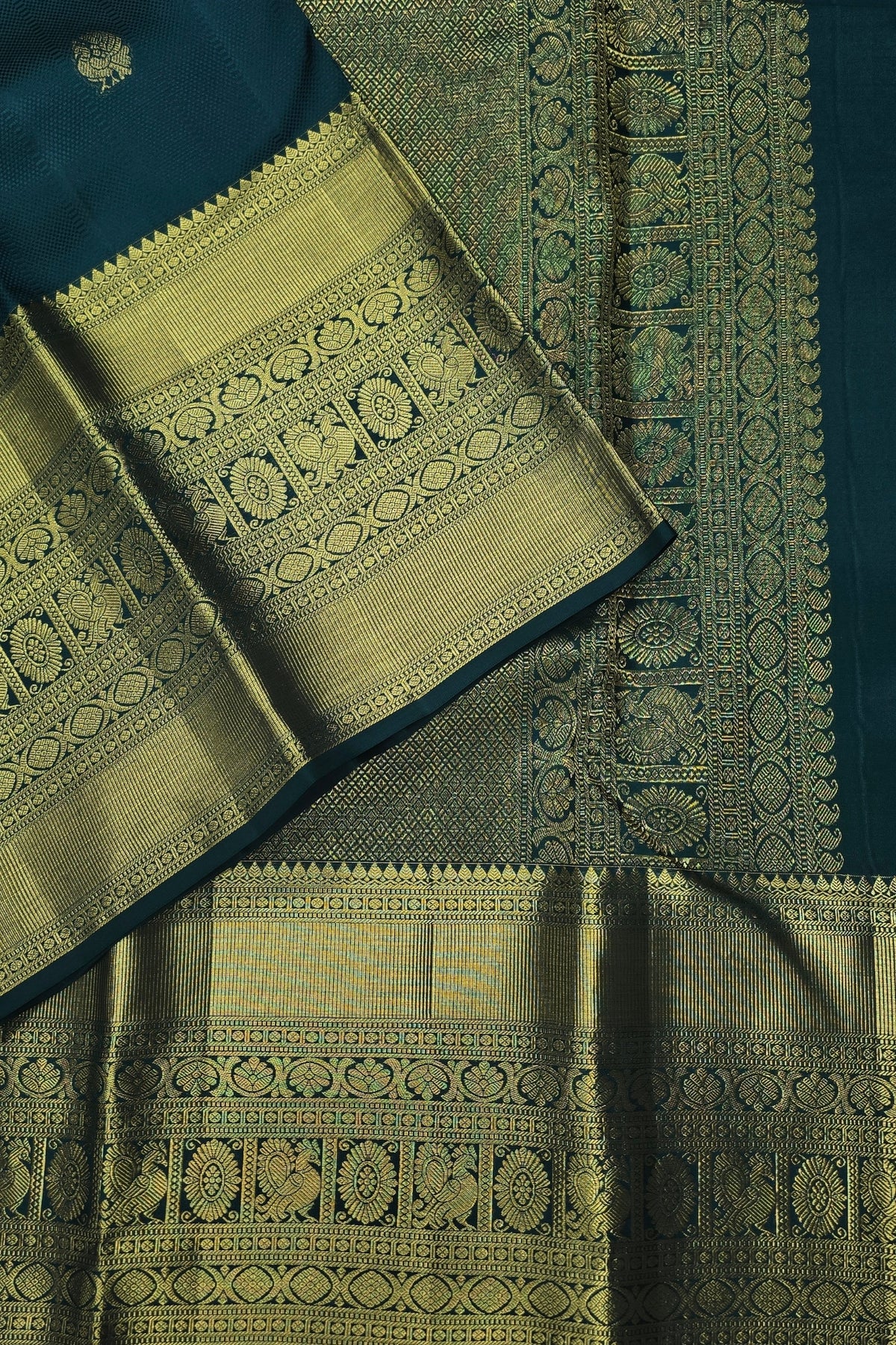 Green and blue traditional fabric with intricate patterns