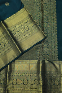 Green and blue traditional fabric with intricate patterns
