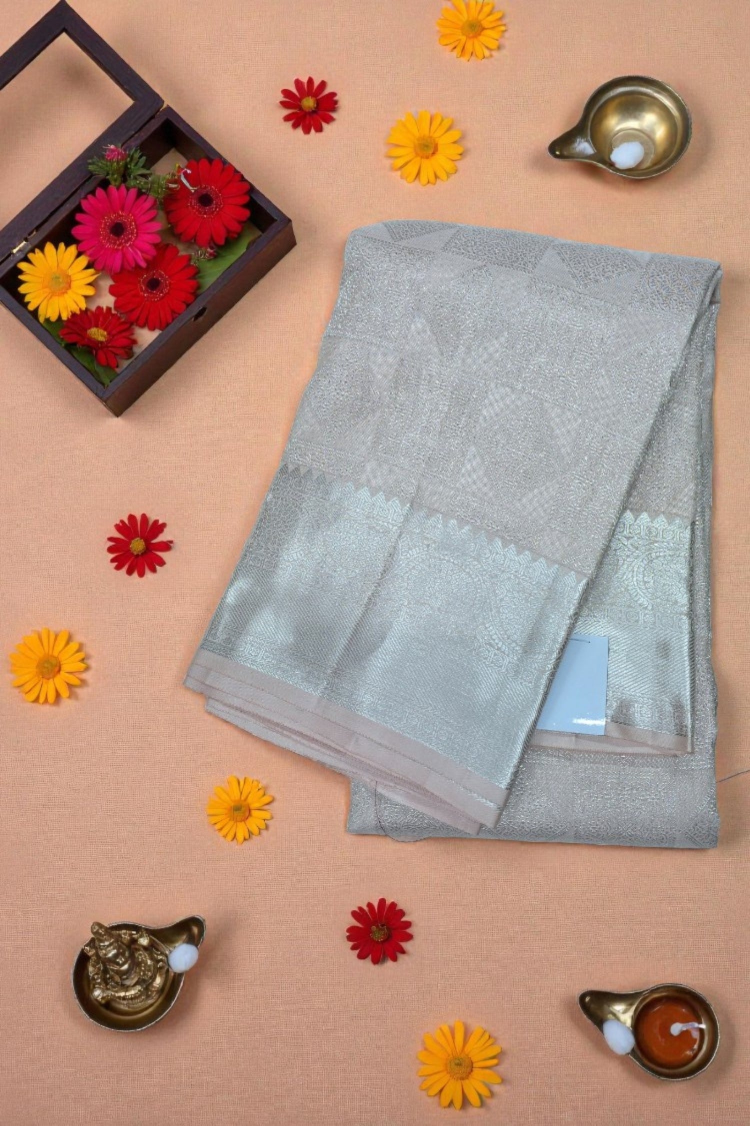 Gray saree with a border on a beige background with decorative elements